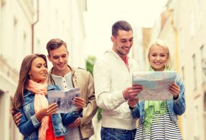 34811772 - travel, vacation and friendship concept - group of smiling friends with city guide and map exploring city